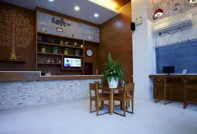 a restaurant with a bar with a table and chairs at Loft 77 in Bangkok