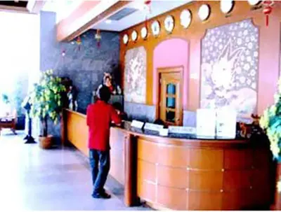 a man standing at the counter of a fast food restaurant at Bangkok City Inn in Bangkok
