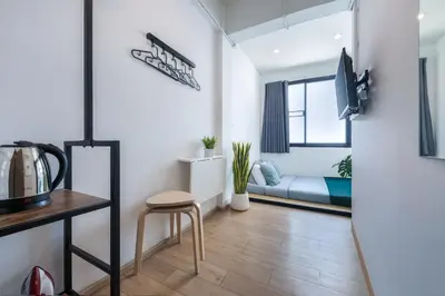 a living room with a couch and a table at Platinum Deluxe Shopping Apartments in Bangkok