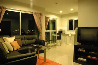 a living room with a couch and a television at Bangkok Living in Bangkok