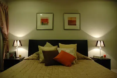 a bedroom with a bed with pillows and two lamps at Bangkok Living in Bangkok