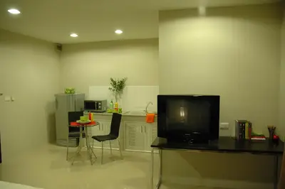 a living room with a television and a table with chairs at Bangkok Living in Bangkok