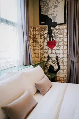 a bedroom with two white beds and a window at Azure Hostel Bangkok in Bangkok