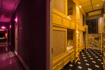 a room with yellow shelves and a checkered floor at Azure Hostel Bangkok in Bangkok