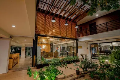 a lobby of a building with a lot of plants at Peace Land Khaosan in Bangkok