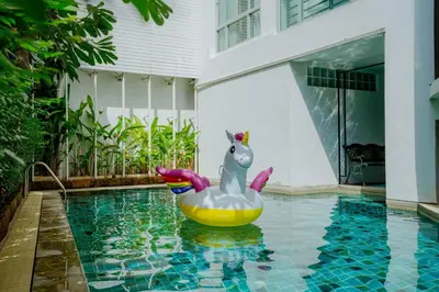 a pool with a inflatable unicorn in the water at Peace Land Khaosan in Bangkok