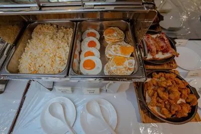 a refrigerator filled with different types of food at Peace Land Khaosan in Bangkok