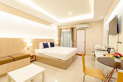 a hotel room with a bed and a table at Tree Place in Bangkok