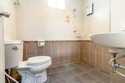 a bathroom with a toilet and a sink at Tree Place in Bangkok