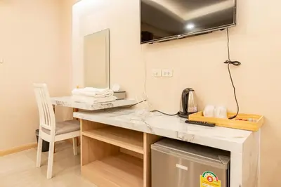 a room with a desk with a chair and a mirror at Tree Place in Bangkok