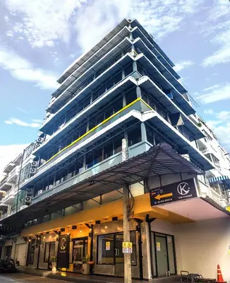 a large building with an umbrella in front of it at Kim Korner Hotel in Bangkok
