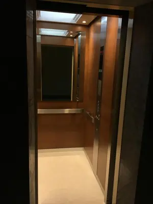 a glass door with a television in a room at Baan Wanchart in Bangkok