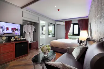a bedroom with a bed and a couch and a table at Villa De Khaosan by Chillax in Bangkok