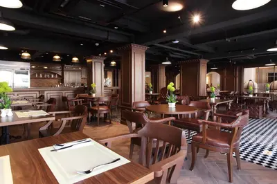 a restaurant with wooden tables and chairs and a dining room at Villa De Khaosan by Chillax in Bangkok