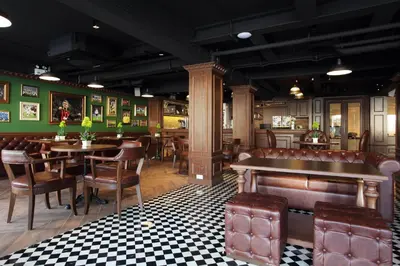 a restaurant with tables and chairs in a room at Villa De Khaosan by Chillax in Bangkok