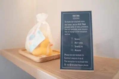 a sign on a shelf with a bag of food at Kritthai Residence in Bangkok