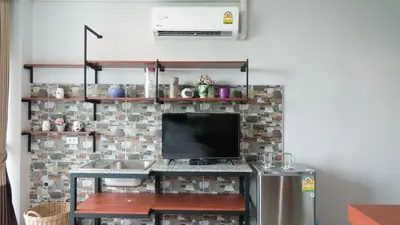 a kitchen with a sink and a tv in a room at Today Tonight in Bangkok