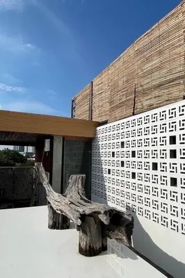 a building with a tree stump in front of a building at Blu Cabin Ari Stylish Gay Poshtel in Bangkok
