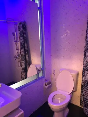 a bathroom with a white toilet and a sink at Blu Cabin Ari Stylish Gay Poshtel in Bangkok