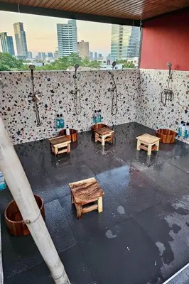 a room with benches and tables on a building at Blu Cabin Ari Stylish Gay Poshtel in Bangkok