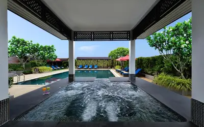 a swimming pool in the middle of a house at Centre Point Plus Hotel Pratunam in Bangkok