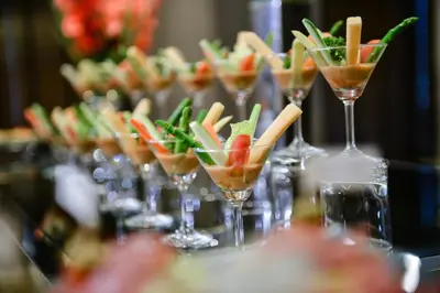 a row of wine glasses filled with fruit and vegetables at Centre Point Hotel Chidlom Bangkok in Bangkok