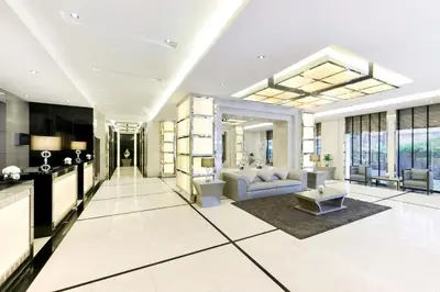 a living room with a couch and a table at Centre Point Hotel Chidlom Bangkok in Bangkok