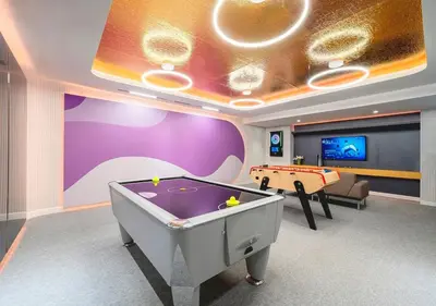 a room with a pool table and a tv at Centre Point Sukhumvit 10 in Bangkok