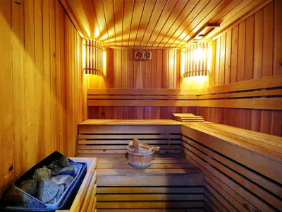 an empty wooden sauna with a bucket in it at Centre Point Sukhumvit 10 in Bangkok