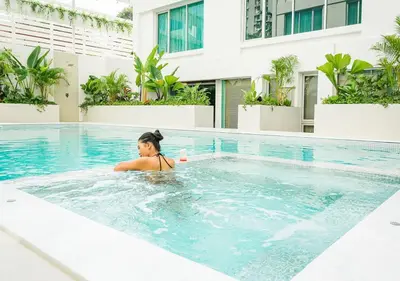 a woman in a swimming pool at a hotel at Centre Point Sukhumvit 10 in Bangkok
