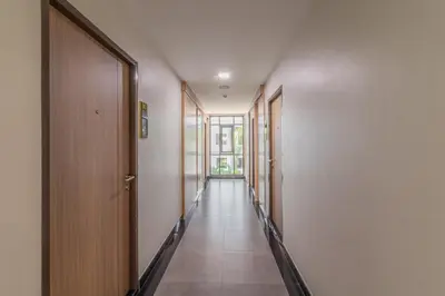 an empty hallway with doors and a hallwayngth at Casa Luxe Hotel and Resident in Bangkok