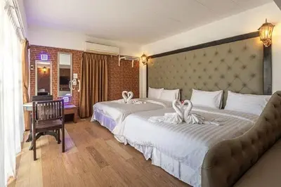 a hotel room with two beds with towels on them at SUDYOD HOTEL in Ban Bang Bamru