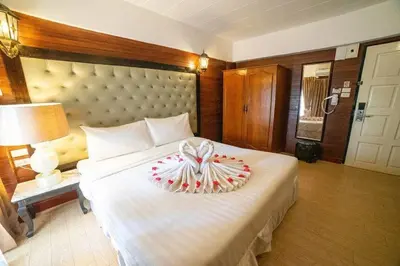 a bedroom with a large bed with a bow on it at SUDYOD HOTEL in Ban Bang Bamru