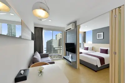 a hotel room with a bed and a tv at Arize Hotel Sukhumvit in Bangkok