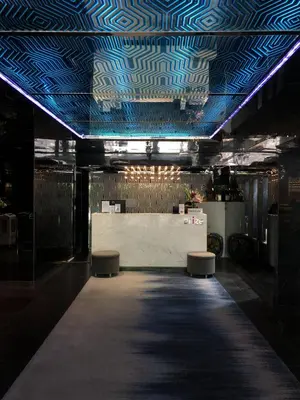 a room with a ceiling with blue lights and benches at Arize Hotel Sukhumvit in Bangkok