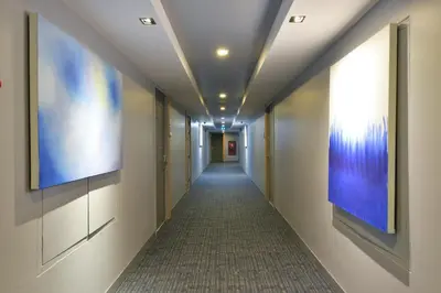 a corridor of a hallway with a long hallway at Arize Hotel Sukhumvit in Bangkok