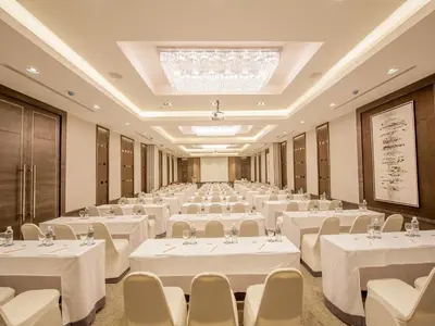 a large banquet hall with white tables and chairs at Arize Hotel Sukhumvit in Bangkok