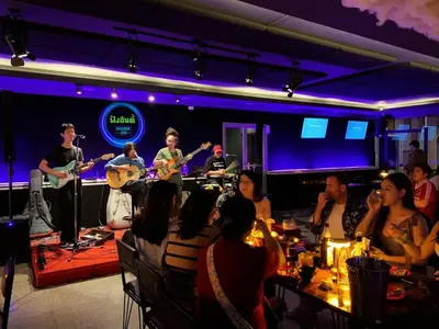 a group of people sitting in a room playing music at Bay Hotel Srinakarin in Bangna