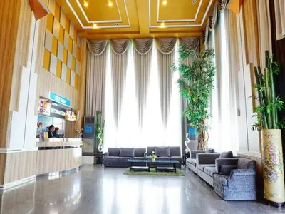 a lobby with couches and chairs in a building at Bay Hotel Srinakarin in Bangna