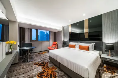 a hotel room with a large bed and a desk and chair at Hotel JAL City Bangkok in Bangkok