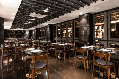 a restaurant with tables and chairs in a room at Hotel JAL City Bangkok in Bangkok