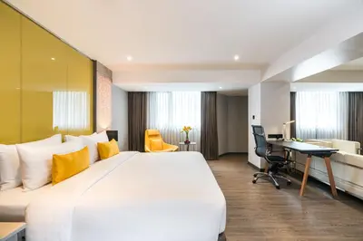 a hotel room with a large bed and a desk at Hotel JAL City Bangkok in Bangkok