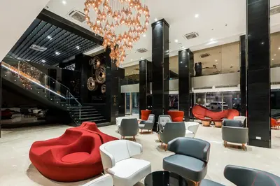a lobby with a red couch and chairs at Hotel JAL City Bangkok in Bangkok