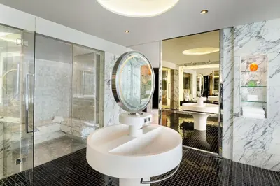 a bathroom with a sink and a mirror at W Bangkok Hotel in Bangkok