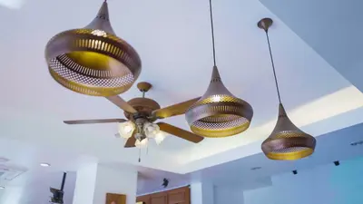 a ceiling fan with three lights on a ceiling at Korbua House in Bangkok