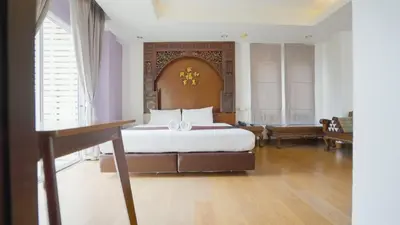 a bedroom with a large bed in a room at Korbua House in Bangkok