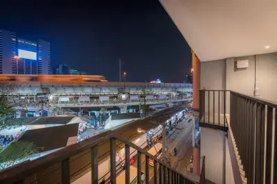 a view of a shopping mall at night at Yello Rooms Hotel Victory Monument in Bangkok