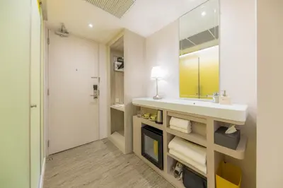 a bathroom with a sink and a mirror at Yello Rooms Hotel Victory Monument in Bangkok