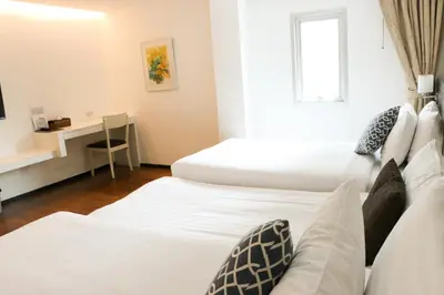 a hotel room with two beds and a desk at The Mini R Ratchada in Bangkok