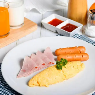 a plate of food with meat and carrots on a table at The Mini R Ratchada in Bangkok